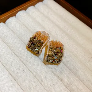 Macro detail of vintage French style earrings with crystals and mini pearls in a display tray