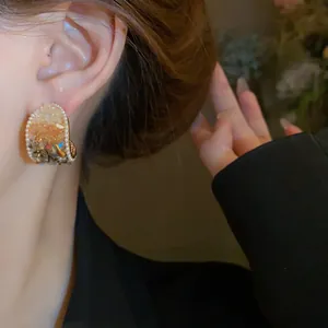 Close-up detail of French vintage geometric earrings with pearls and colorful crystals