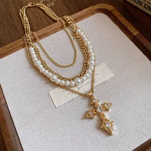 Detailed shot of vintage multi-layer necklace with pearls and diamond-encrusted cross