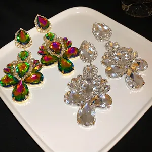 Close-up of sparkling teardrop crystal dangle earrings in iridescent and clear colors