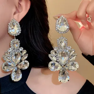 Close-up of sparkling teardrop crystal statement earrings showing exquisite chandelier details