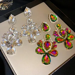 Close-up of sparkling rhinestone waterdrop earrings in clear and iridescent colors.