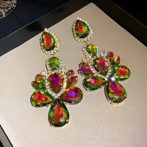 Close-up of luxury water drop dangle earrings with vibrant colorful iridescent rhinestones