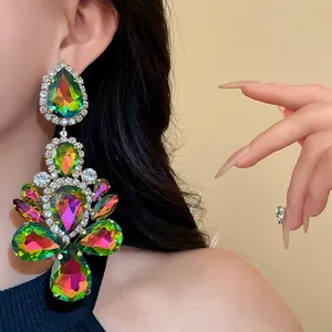 Macro detail of oversized iridescent waterdrop earrings with crystal pavé finish