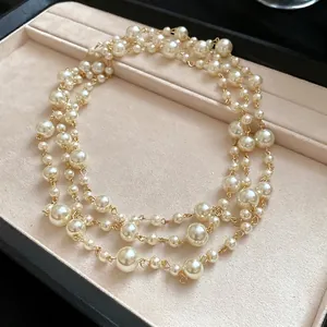 Elegant French vintage multi-layer pearl necklace presented in a velvet jewelry tray.