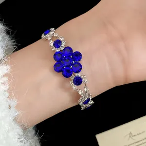 Elegant vintage style flower bracelet featuring sparkling deep blue rhinestones on a wrist
