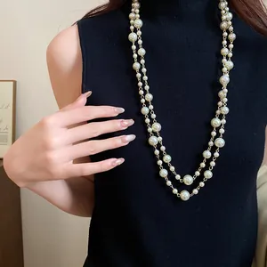 Close-up of elegant French vintage multi-layer pearl long necklace on a model