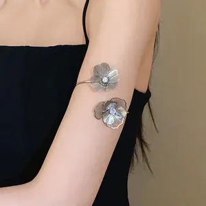 Detail shot of an elegant silver flower open armlet with sparkling rhinestones.
