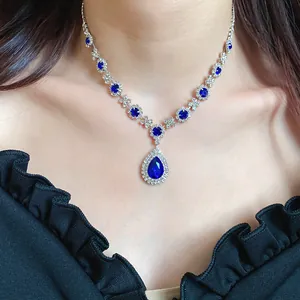Elegant blue water-drop rhinestone necklace in vintage royal style on model neck.