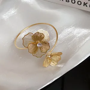 Detailed view of the gold mesh flower bangle with sparkling center rhinestones