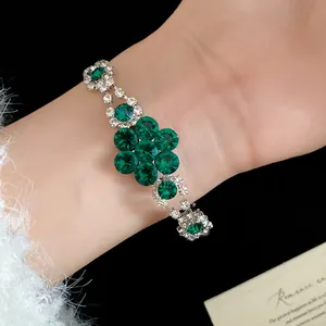 Detailed close-up of a green rhinestone flower bracelet with elegant sparkling stones