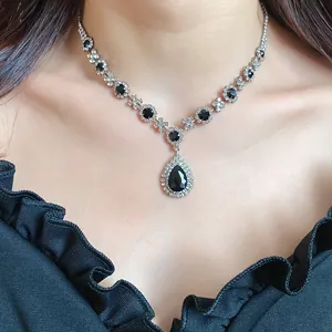 Detail view of retro palace style necklace with black water drop gemstone pendant