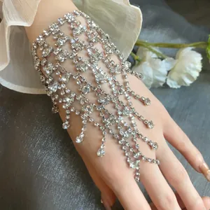 Close-up view of a sparkling multi-layer rhinestone fringe bracelet worn on a lady's hand