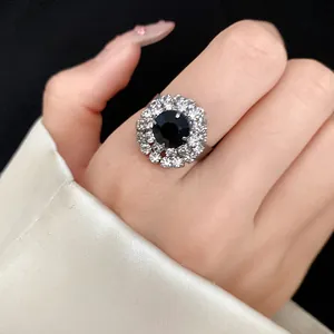Macro detail of a vintage flower ring with black gemstone and sparkling crystals.