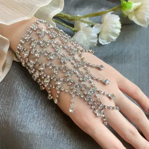 Close-up detail view of sparkling silver rhinestone fringe hand harness slave bracelet.