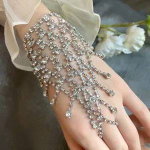 Macro detail view of sparkling multi-layered rhinestone tassel hand chain bracelet