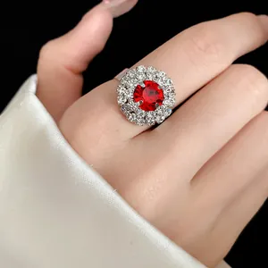 Detailed close-up view of a vintage style red crystal ring with sparkling rhinestone halo