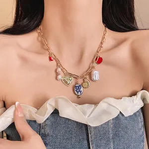 Chic gold charm necklace with baroque pearl heart and red chili pendants for women