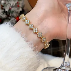 Detailed view of gold plated flower bracelet with sparkling cubic zirconia on wrist