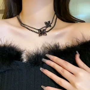 Close-up of elegant black double-layered choker necklace with sparkling clover charms