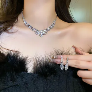 Sparkling zircon necklace and drop earrings set shown on an elegant model's neck