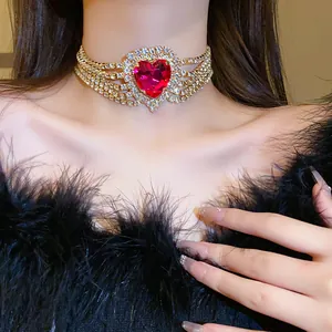 Close-up of luxury choker necklace featuring a large red heart gemstone and rhinestones.
