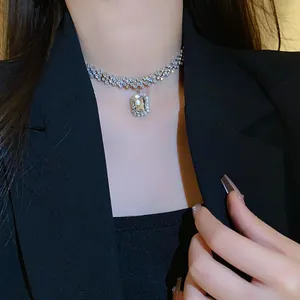 Close-up view of an elegant silver choker necklace with a large emerald-cut zircon pendant
