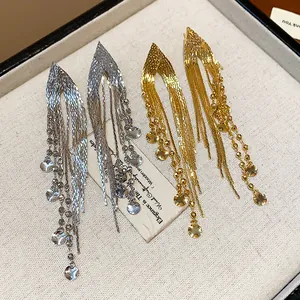 Elegant 18k gold plated long tassel earrings with shimmering sequin details in box.