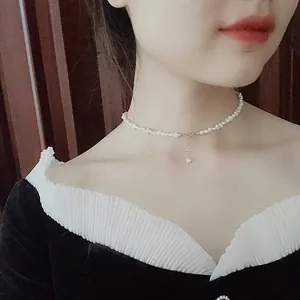 Elegant French Baroque pearl choker necklace detailed view worn on model's slender neck