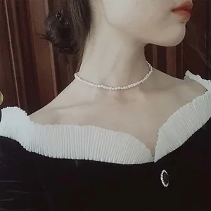 Close-up detail of a French Baroque pearl choker necklace worn by an Asian model