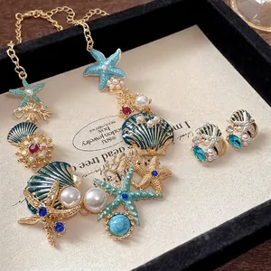 Elegantes Halsketten-Set mit Seestern- und Muschelperlen, blauer Emaille und Strass