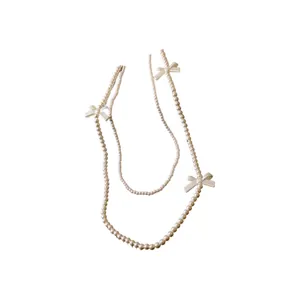 Collier élégant en fausses perles à double rang avec nœuds décoratifs