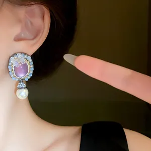Close-up of vintage palace style oval butterfly pearl earring on ear
