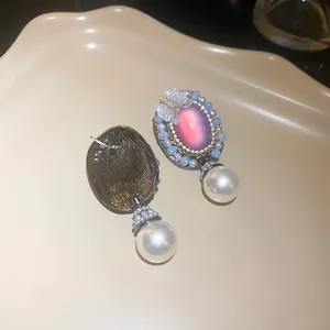 Detail view showing the front and back of elegant retro butterfly pearl drop earrings