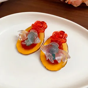 Exquisite vintage Chinese style resin earrings featuring koi carp and red rose designs.