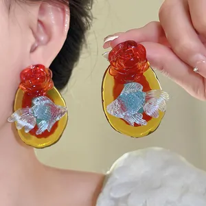 Macro view of resin koi fish and rose earrings showing intricate vintage oriental details