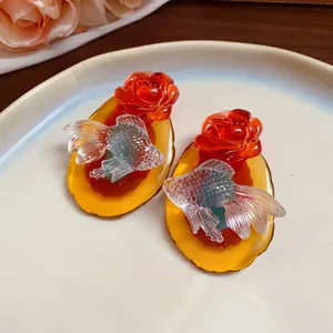 Macro detail of New Chinese style resin goldfish rose earrings with silver needles