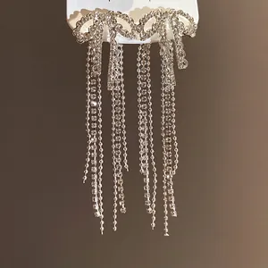 Sparkling zirconia bow tassel earrings with silver needles for a sophisticated look