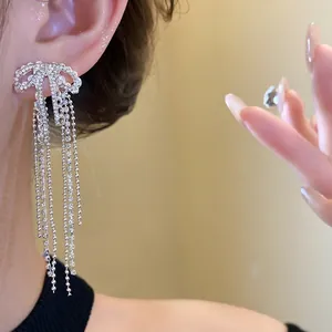 Elegant silver zircon bow tassel earrings with long dangling chain detail