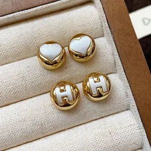 Elegant minimalist round stud earrings with heart and H-letter designs in a gold finish