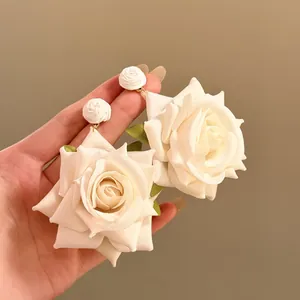 Elegant cream white fabric rose drop earrings for a chic summer beach vacation style