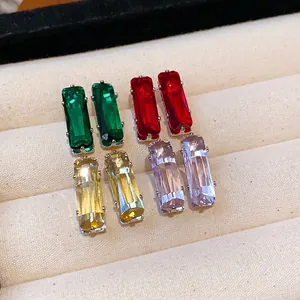 Elegant rectangular zircon stud earrings in four colors displayed on a jewelry tray.