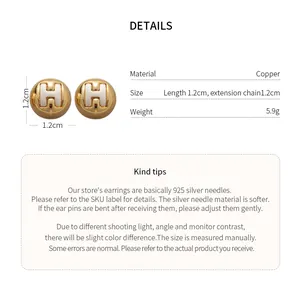 Detail view of round stud earrings with H logo, including size and material specifications