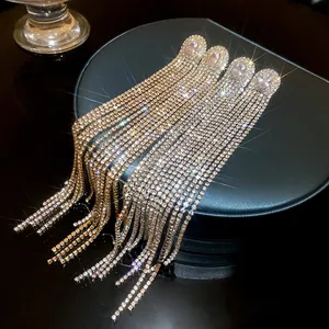 Macro close-up of elegant oval cubic zirconia earrings with long rhinestone tassels