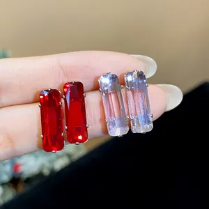 Detailed view of elegant square cut zircon stud earrings in red and light lavender colors.
