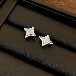 Detailed macro shot of sparkling star-shaped silver stud earrings with cubic zirconia