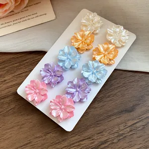 Detailed view of 10-piece floral stud earring set with colorful pearlescent finish