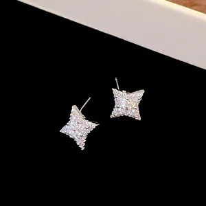 Exquisite silver-toned four-pointed star stud earrings featuring brilliant cubic zirconia stones