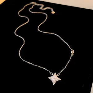 Close-up of sparkling zirconia star pendant necklace on elegant silver chain.