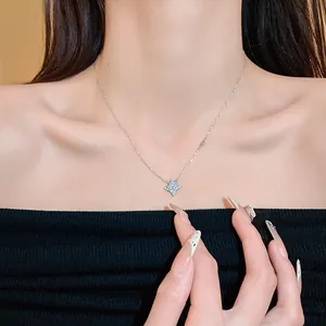 Detailed view of a silver star pendant necklace with cubic zirconia on an Asian model's neck